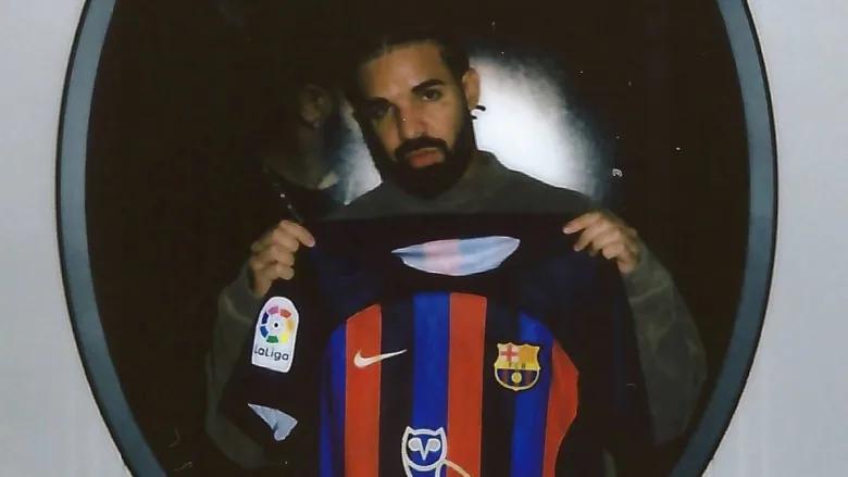 Drake holds an FC Barcelona jersey featuring his owl-shaped logo that will be worn for the club's upcoming match against Real Madrid. (@FCBarcelona/Twitter)